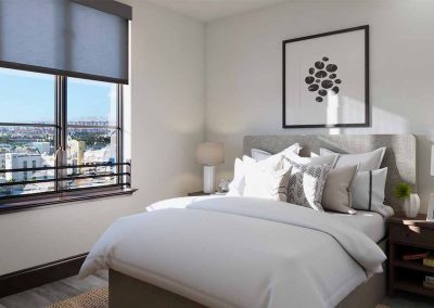 A modern bedroom with a large window offering a city view, featuring a neatly made bed, a bedside table, and a framed artwork above the bed.